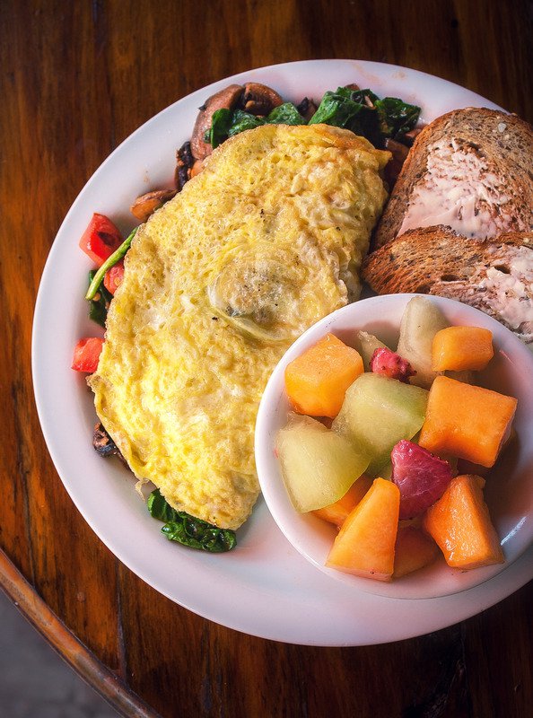 Egg Stuffed With Vegetables Omelet for Breakfast, Fruit, and Toast